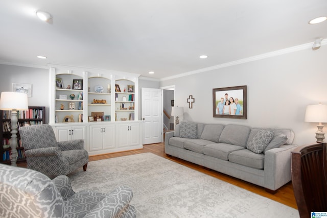 living area with recessed lighting, light wood-style floors, and crown molding