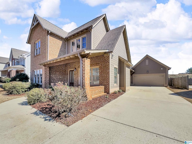 view of home's exterior featuring a garage, fence, brick siding, and roof with shingles