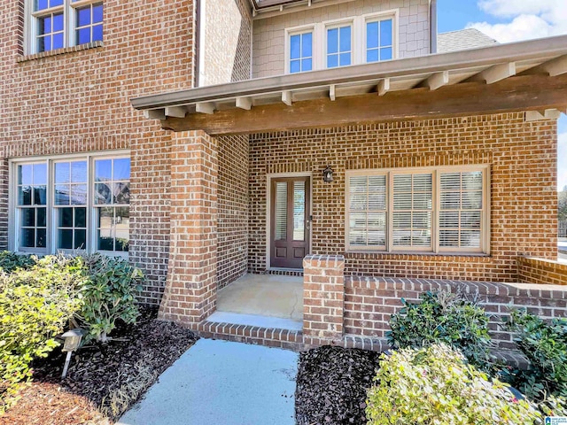 property entrance featuring brick siding