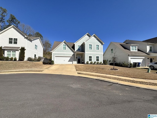 view of front of property featuring board and batten siding, concrete driveway, and a garage