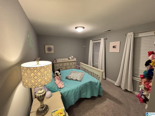 bedroom featuring visible vents, baseboards, and carpet floors