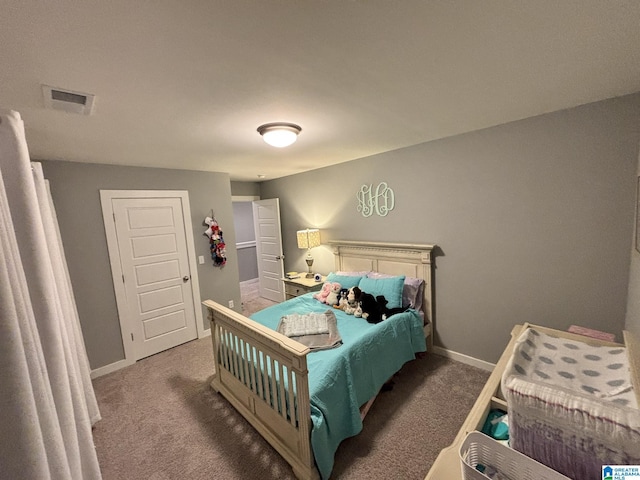 carpeted bedroom featuring baseboards and visible vents