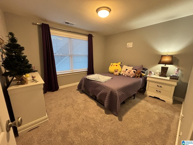 bedroom with light carpet, visible vents, and baseboards