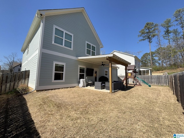 rear view of house with a patio area, a playground, a fenced backyard, and ceiling fan