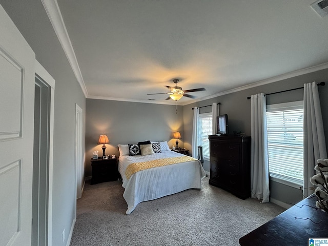 carpeted bedroom featuring visible vents, baseboards, ornamental molding, and a ceiling fan