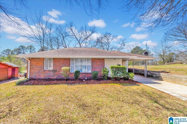 view of front of property featuring a carport, a front yard, brick siding, and driveway