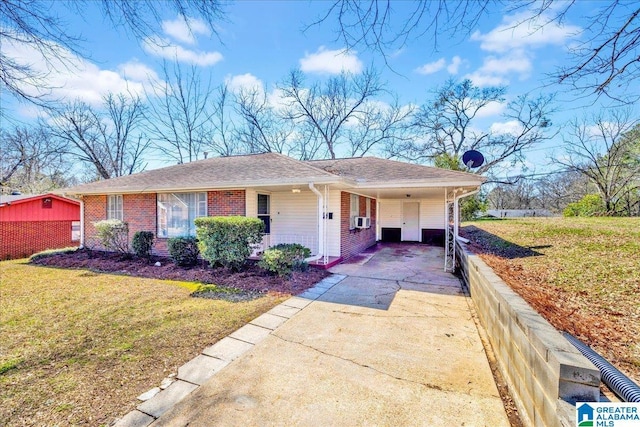 view of front of house with an attached carport, cooling unit, concrete driveway, a front lawn, and brick siding