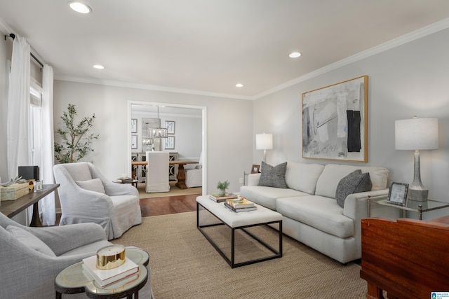 living area with a chandelier, recessed lighting, ornamental molding, and wood finished floors