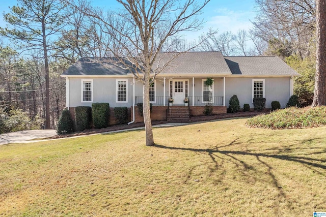 ranch-style house with brick siding, covered porch, a shingled roof, and a front lawn