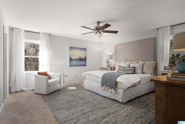 carpeted bedroom with baseboards and ceiling fan