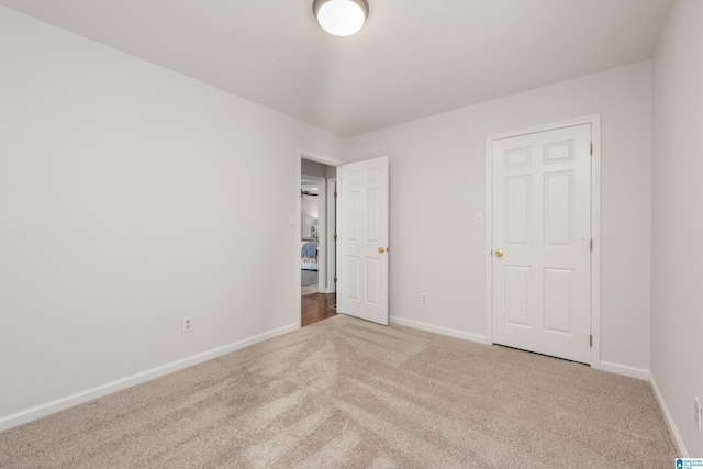 unfurnished bedroom with carpet and baseboards