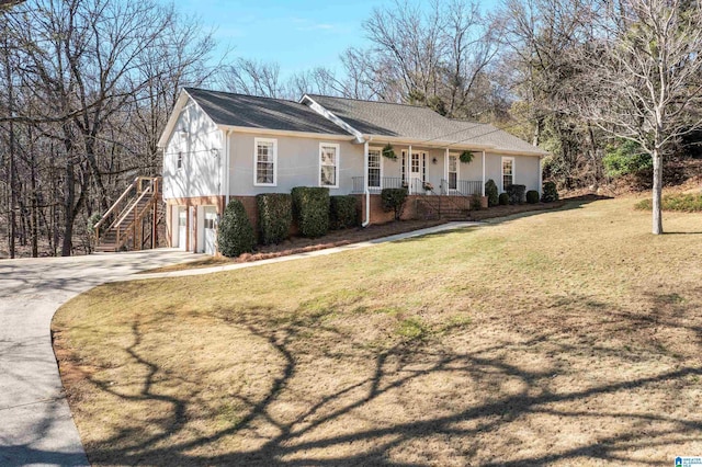 ranch-style home featuring a front lawn, a porch, concrete driveway, an attached garage, and brick siding