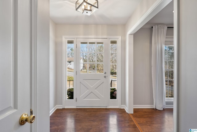 entryway with wood finished floors and baseboards