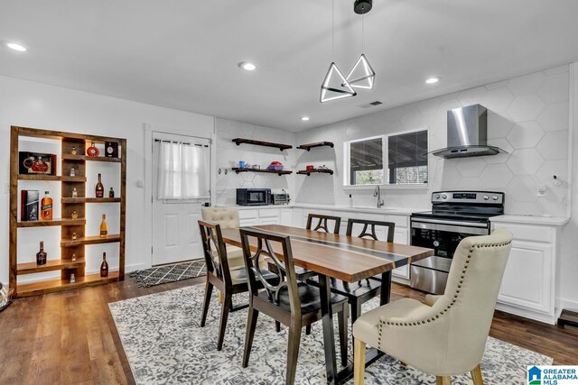 dining space featuring dark wood finished floors, recessed lighting, and visible vents