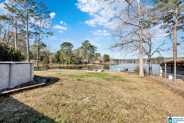 view of yard featuring fence and a water view