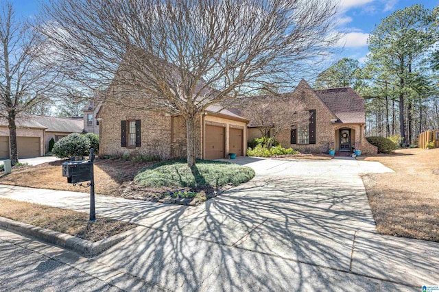 view of front of house with brick siding, concrete driveway, and a garage