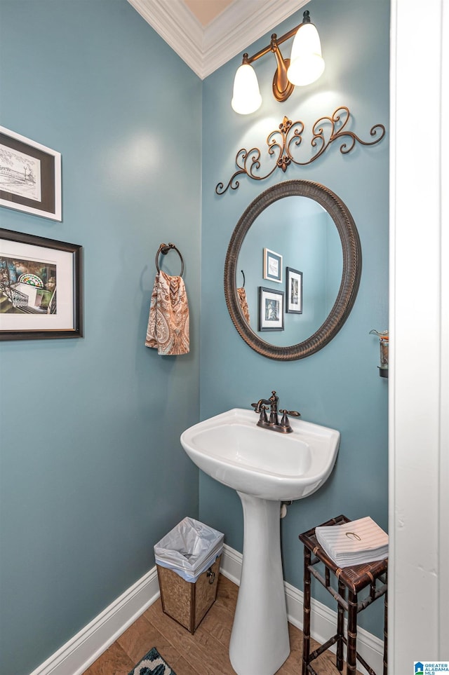 bathroom with crown molding and baseboards