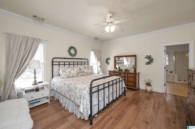 bedroom featuring multiple windows, wood finished floors, and visible vents