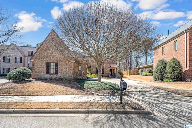 view of front of home with fence and brick siding