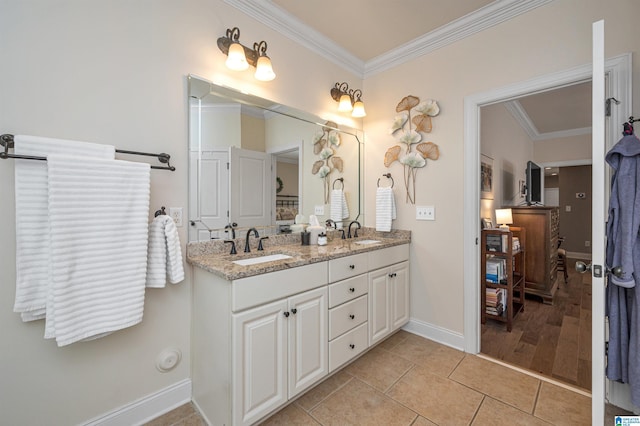 full bath with tile patterned flooring, double vanity, crown molding, and a sink