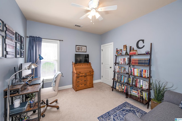 carpeted home office with visible vents, baseboards, and a ceiling fan