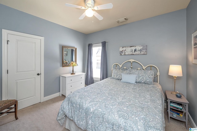 carpeted bedroom featuring baseboards, visible vents, and ceiling fan