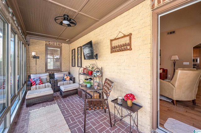 sunroom / solarium with visible vents, wooden ceiling, and a ceiling fan