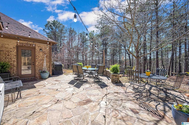 view of patio with outdoor dining area and area for grilling