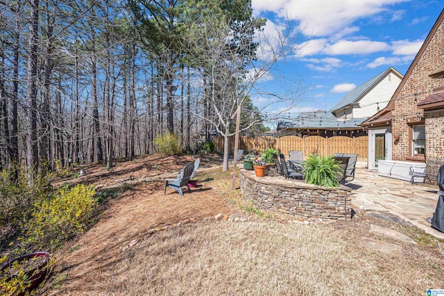 view of yard featuring fence and a patio area