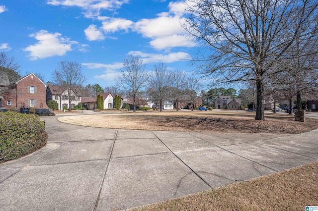 view of road with a residential view and concrete driveway