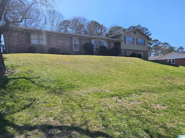 view of front of property with a front yard and brick siding