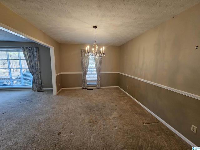 unfurnished dining area with a notable chandelier, plenty of natural light, and carpet floors