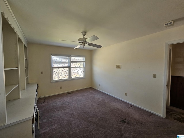 interior space featuring visible vents, ceiling fan, baseboards, and dark colored carpet