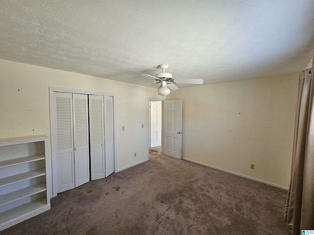 unfurnished bedroom with ceiling fan, baseboards, carpet flooring, a closet, and a textured ceiling