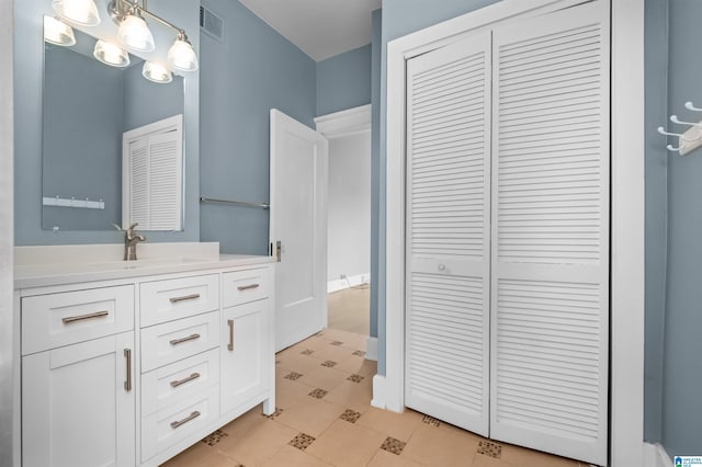 bathroom with a closet, visible vents, and vanity