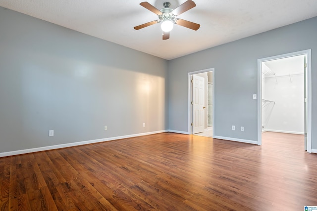 unfurnished room featuring ceiling fan, baseboards, and wood finished floors