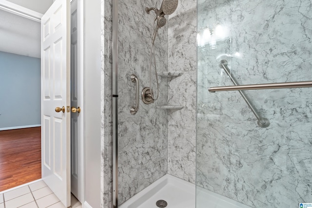 bathroom with tile patterned floors and walk in shower