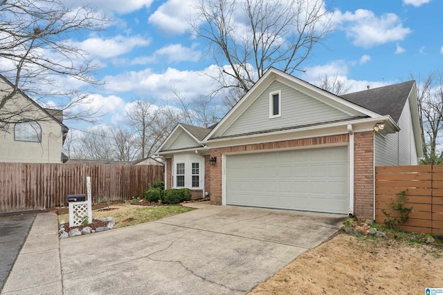 view of front of property with brick siding, concrete driveway, a garage, and fence