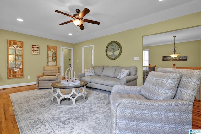 living area featuring recessed lighting, wood finished floors, baseboards, and ceiling fan