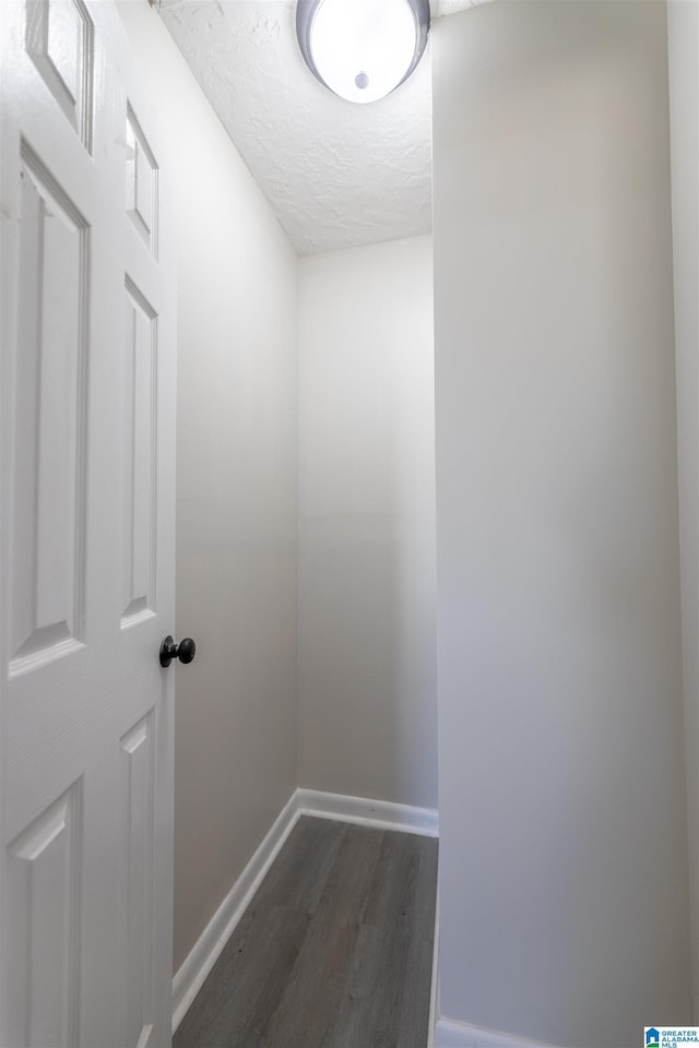 130 Alexandria Heights Cir, Alexandria, AL 36250 - corridor with baseboards, dark wood-type flooring, and a textured ceiling