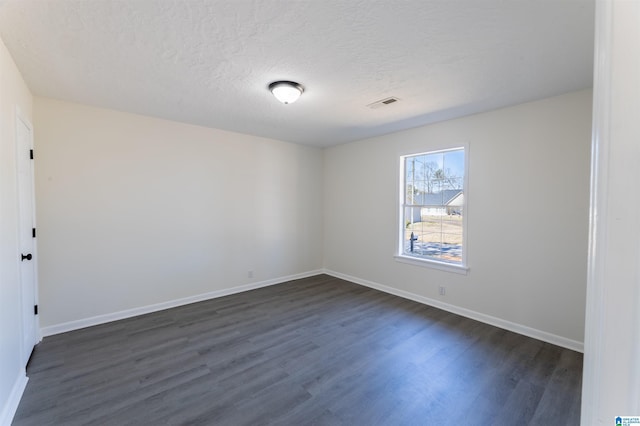130 Alexandria Heights Cir, Alexandria, AL 36250 - empty room featuring baseboards, visible vents, dark wood-style flooring, and a textured ceiling