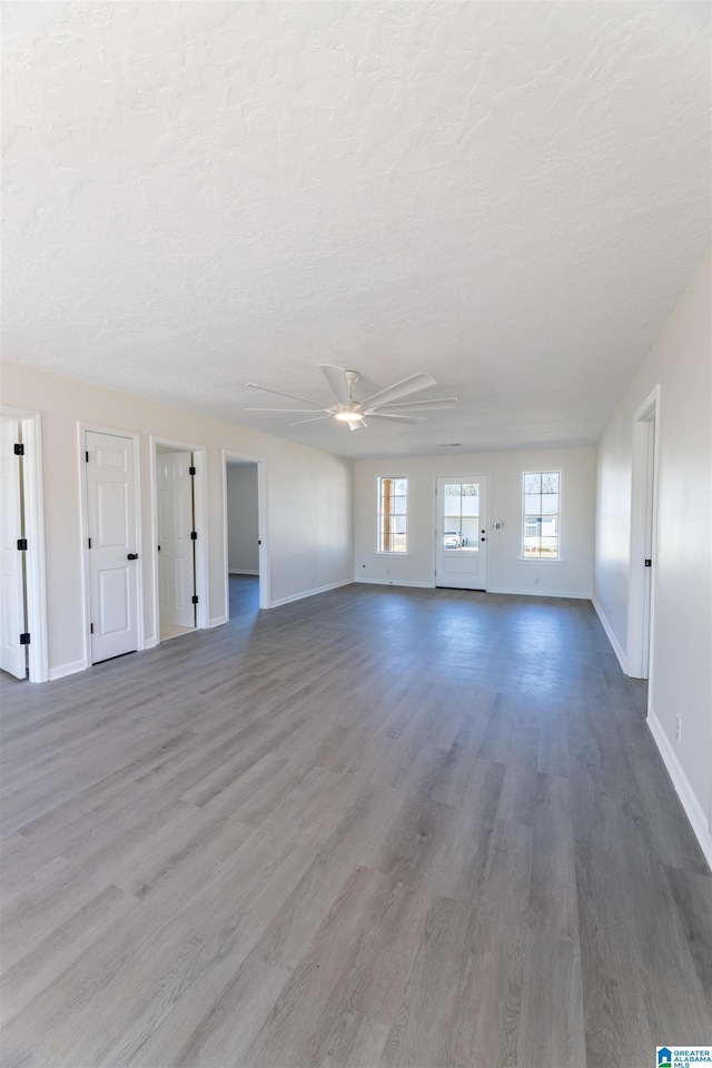 130 Alexandria Heights Cir, Alexandria, AL 36250 - unfurnished living room with a ceiling fan, wood finished floors, baseboards, and a textured ceiling