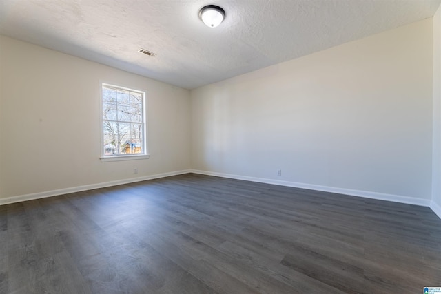 130 Alexandria Heights Cir, Alexandria, AL 36250 - spare room featuring visible vents, baseboards, a textured ceiling, and dark wood finished floors