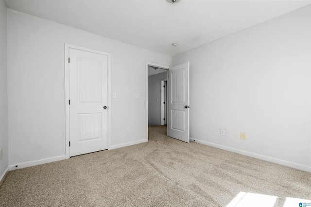 unfurnished bedroom featuring baseboards and carpet floors