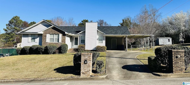 view of front of home featuring a front yard, driveway, a chimney, a carport, and brick siding