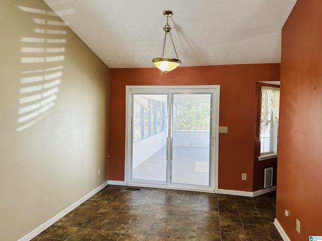 interior space with baseboards and stone finish floor