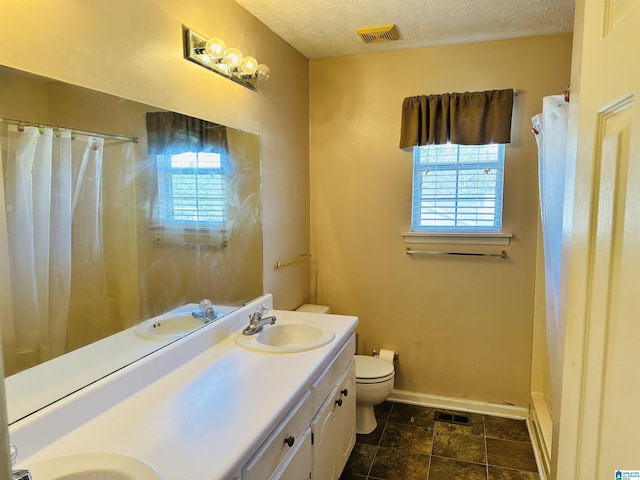 full bathroom featuring a sink, visible vents, baseboards, and a textured ceiling