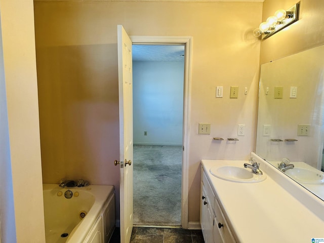 bathroom with baseboards, a tub to relax in, and vanity