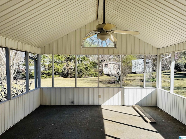 unfurnished sunroom with ceiling fan and vaulted ceiling