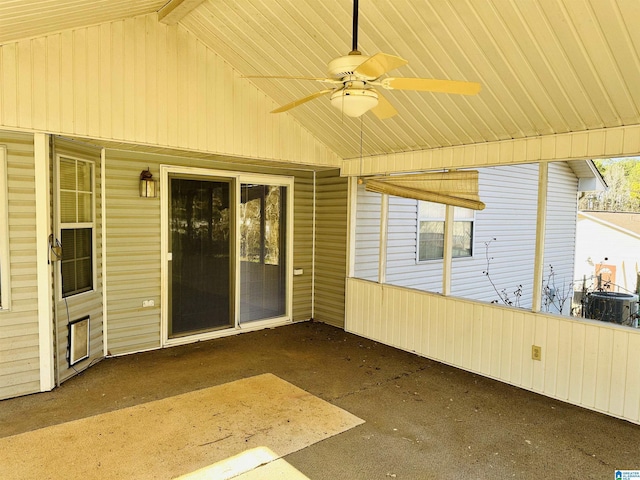 unfurnished sunroom with vaulted ceiling and a ceiling fan